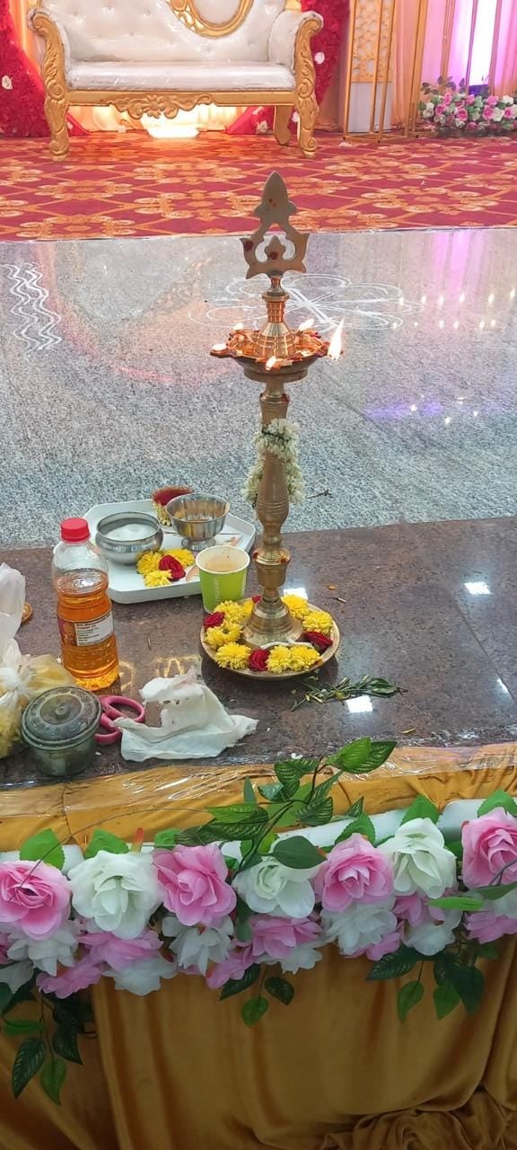 Brass kuthuvilakku lamp and puja items on the stage